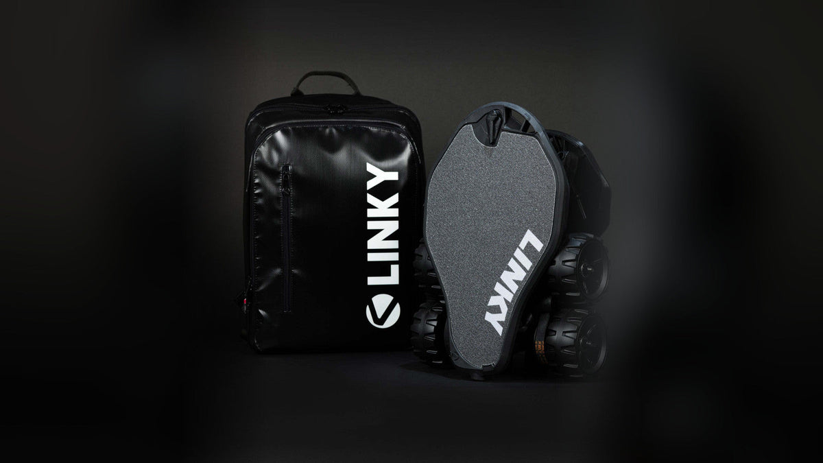 A folded Linky 2.0 board standing beside the Made in Italy backpack it ships with.